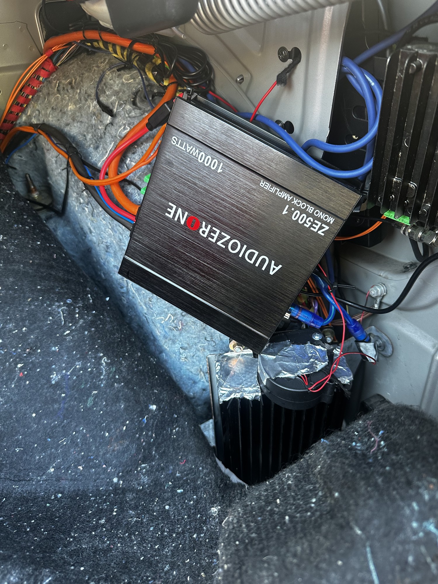 C32 AMG amplifier and power/signal wiring during installation; trim still removed