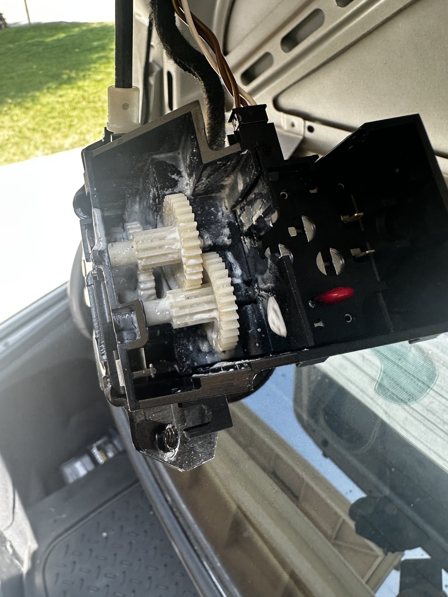 C32 trunk latch actuator reassembled with the gear train in place