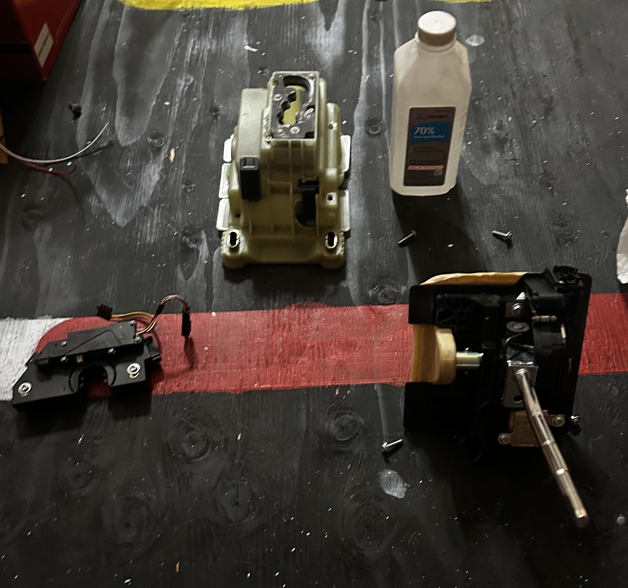 C32 gear selector disassembled on the workbench; housing, lever mechanism, and electronics separated