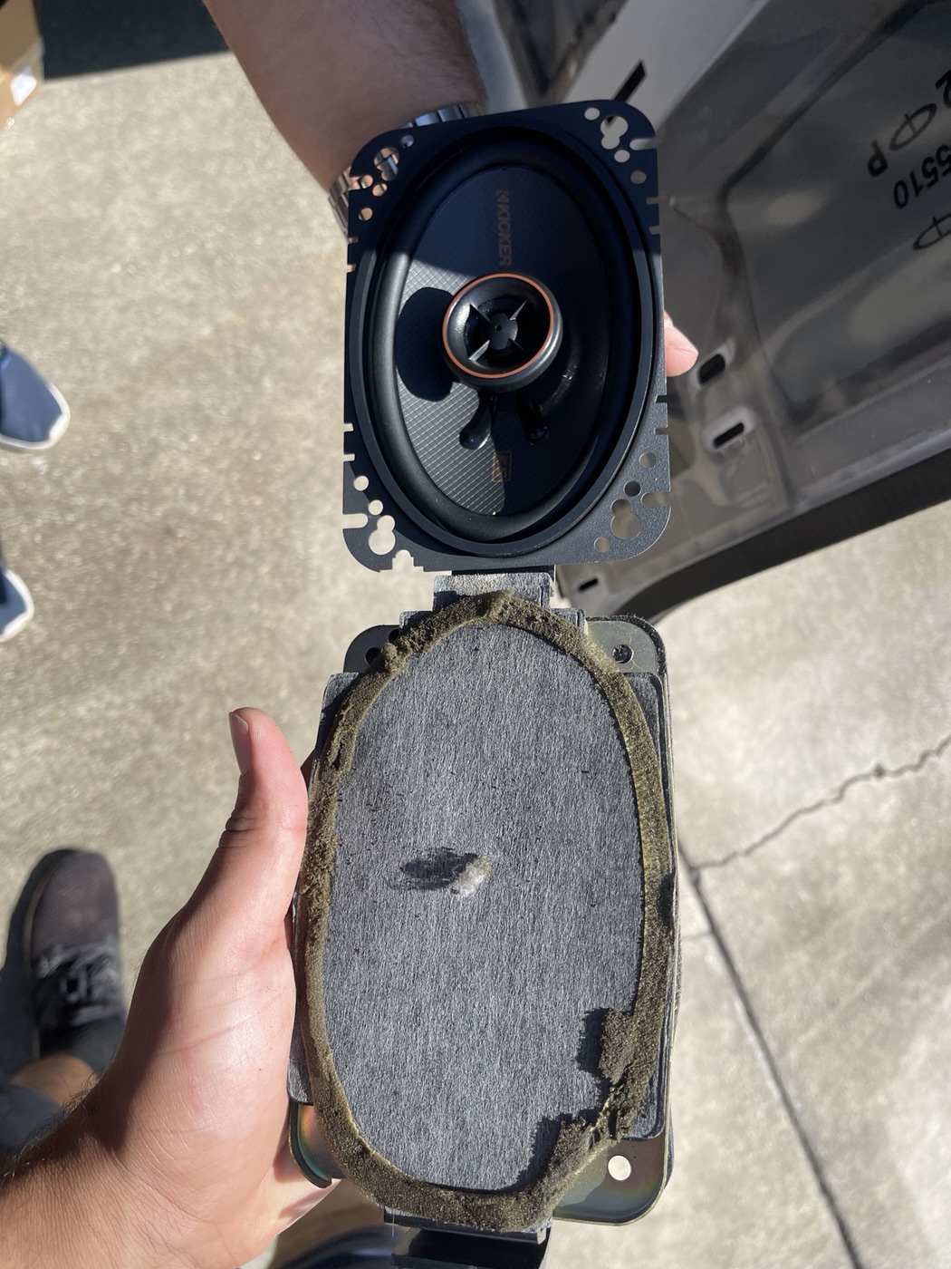 Customer pickup, August 2022: replacement and removed factory door speakers compared before installation