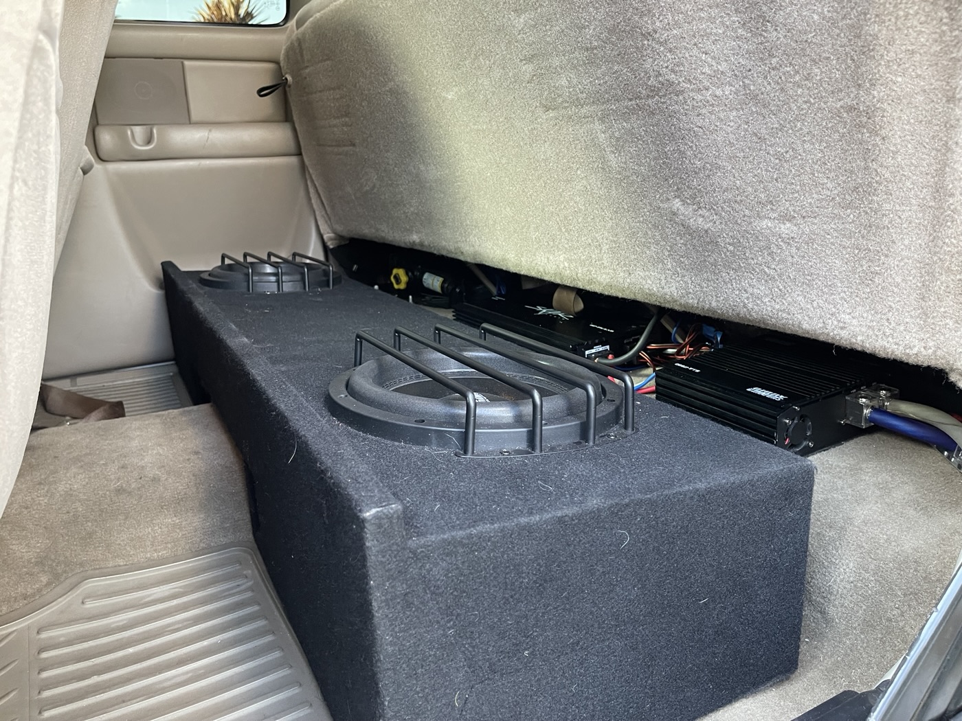 Customer pickup, August 2022: protected subwoofer enclosure fitted beneath the rear seat